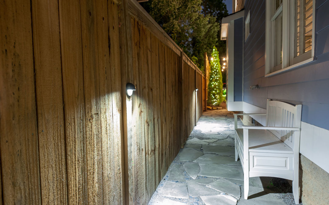 outdoor walkway lit using wall light on frence