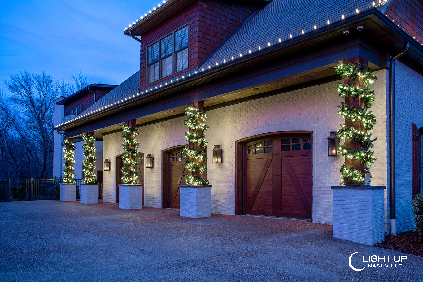 wood columns wrapped in lit garland